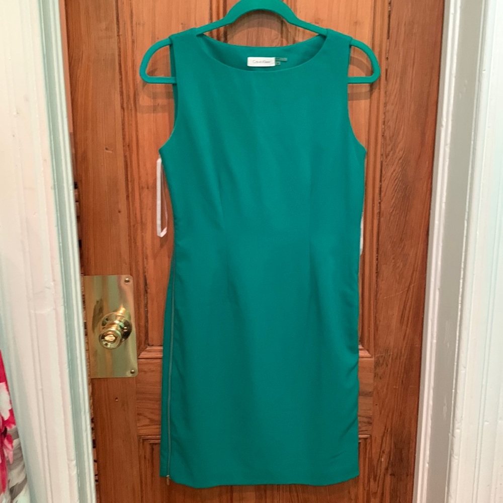 Calvin Klein size 4 grew dress with zippers down the sides.